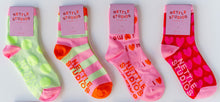 Four pairs of colorful socks with 'Nettle Studios' branding on a white background